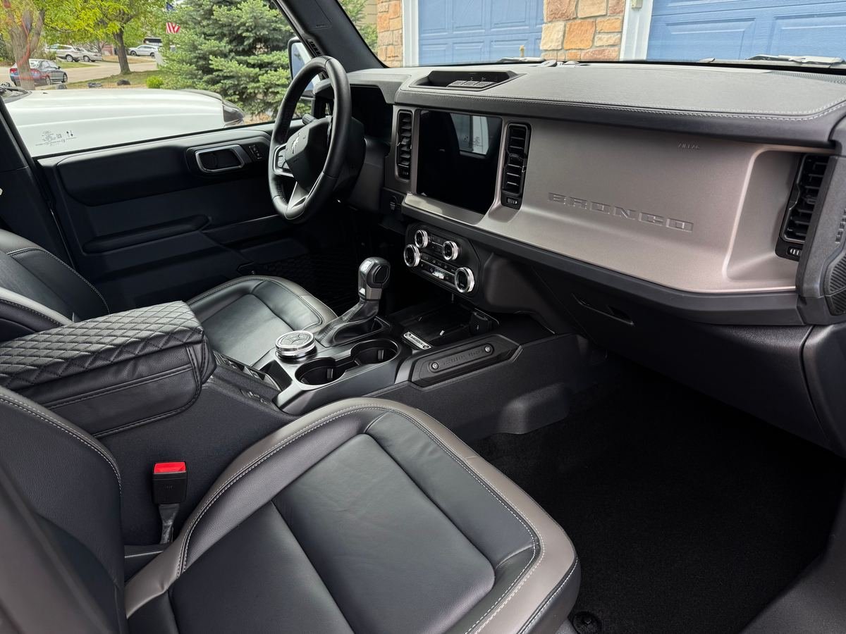 Freshly detailed SUV interior with clean leather front seats, center console and dashboard