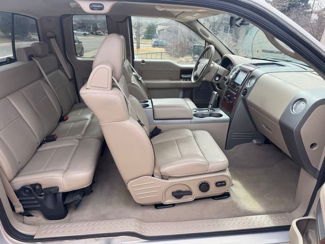 Detailed tan leather front and rear seats and dashboard in a Ford pickup cab