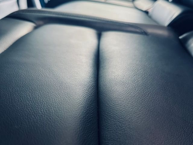 Close-up of a clean, conditioned black leather seat
