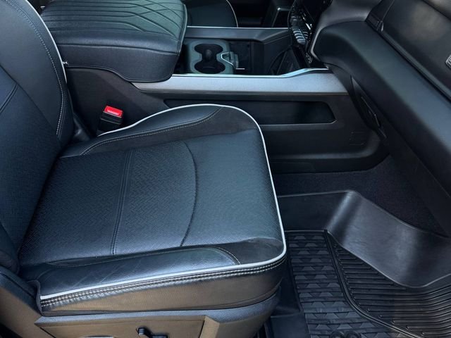 Clean black leather front seat and center console in a Ram pickup